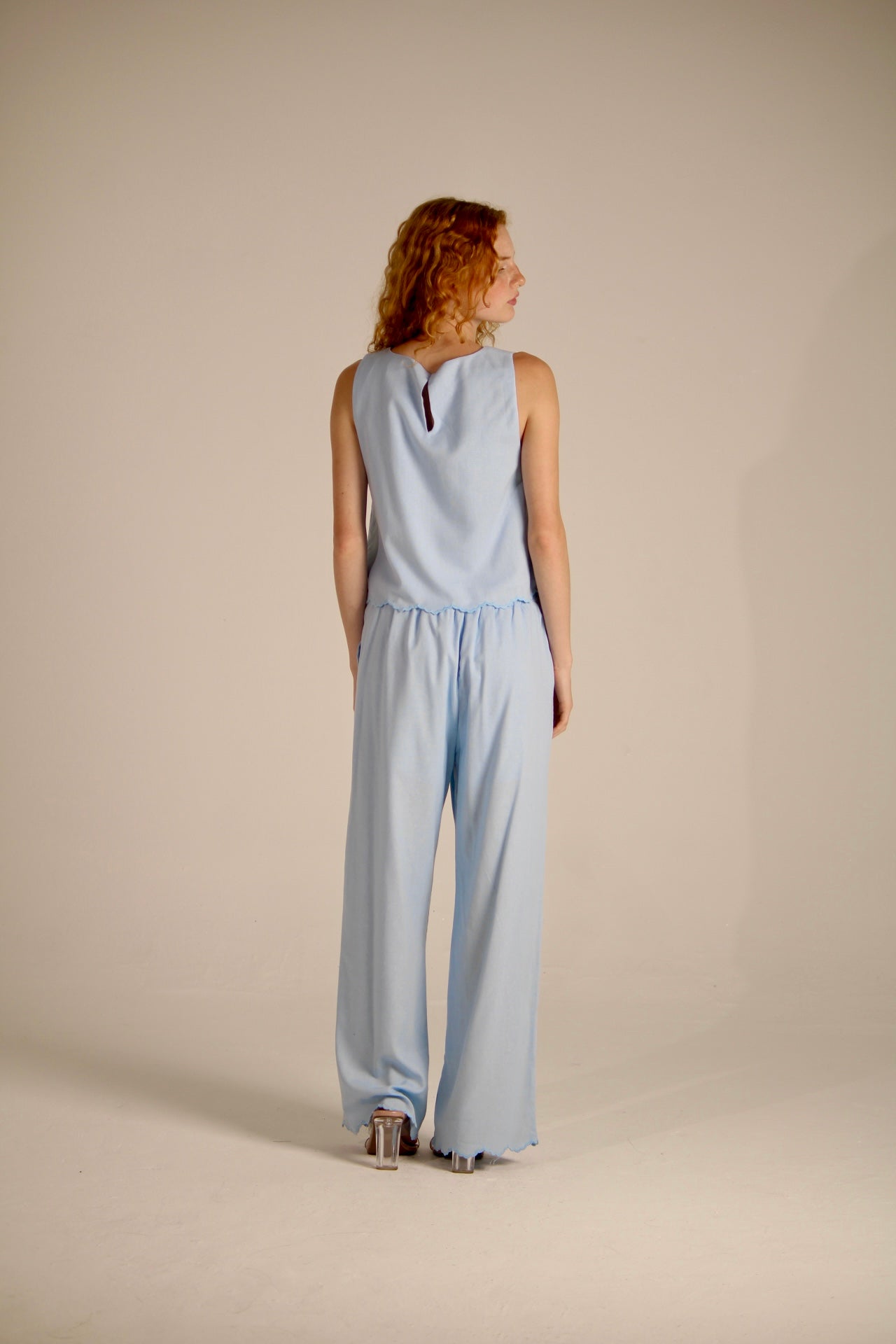 Trousers with perforated flowers